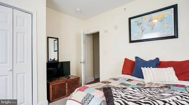 a bedroom with a bed and a flat screen tv