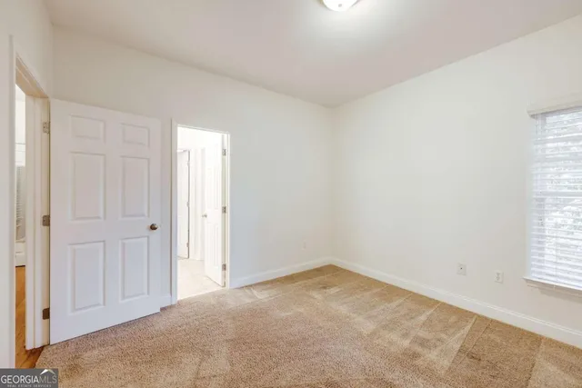 a view of a hallway with wooden floor and entryway