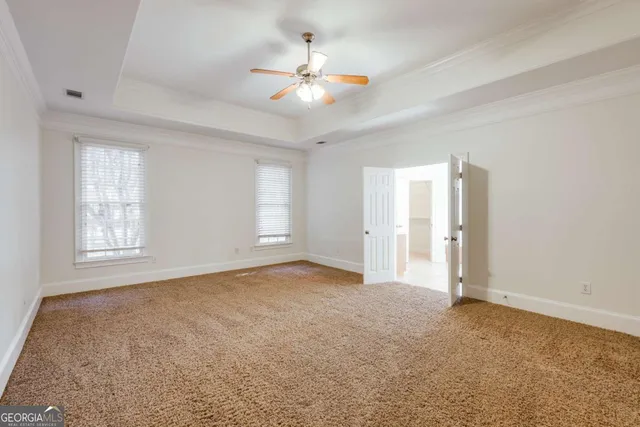 a bathroom with a granite countertop sink a mirror and a bathtub
