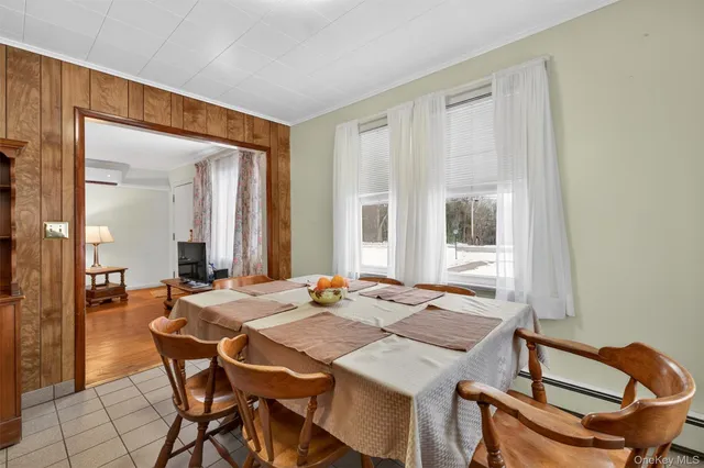 a view of a dining room with furniture and window
