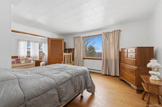 a bedroom with a large bed and a dresser