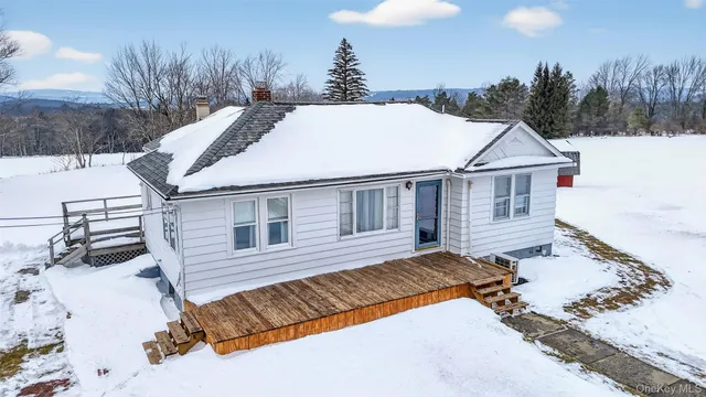 a view of a house with a yard and sitting area