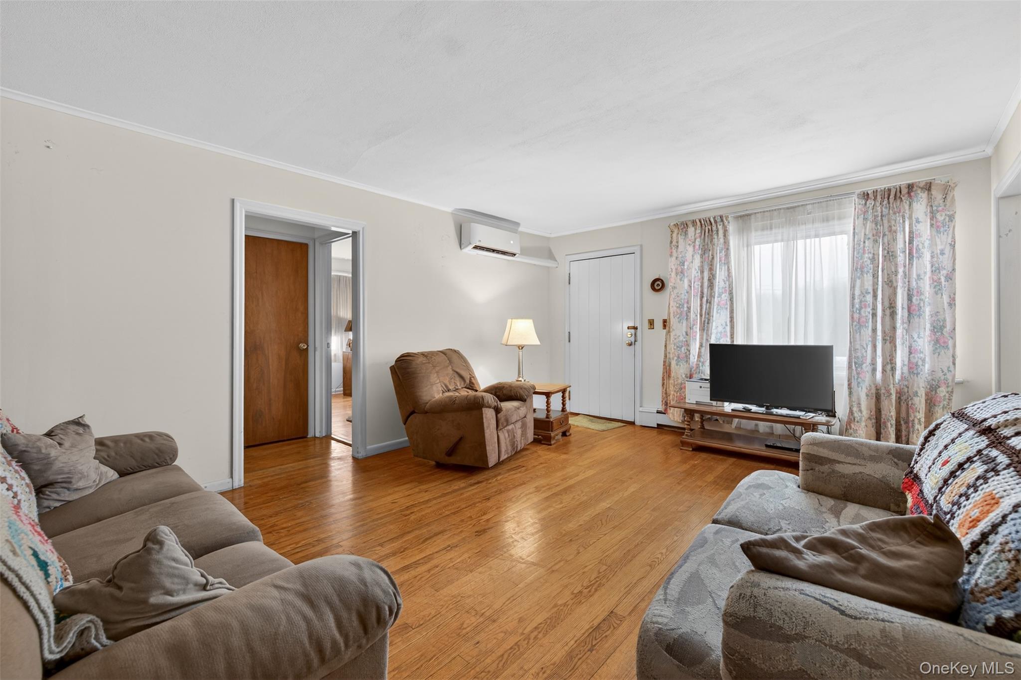 191 Rose Road Woodbourne, NY 12788 - Photo 8 of 47 Living area with hardwood floors, window looking to the front yard and neutral walls