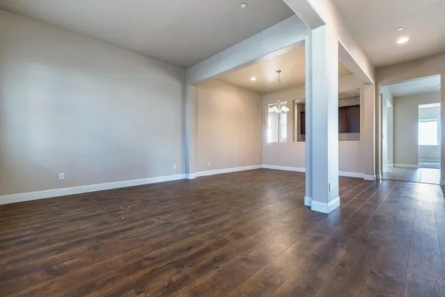 a large kitchen with stainless steel appliances kitchen island granite countertop a large counter top and a stove top oven