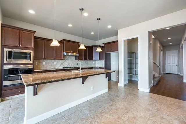 a view of a livingroom with a ceiling fan and window
