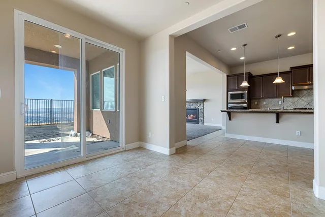 an empty room with a window and a ceiling fan