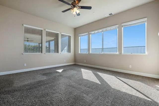 a view of a livingroom with a ceiling fan and window