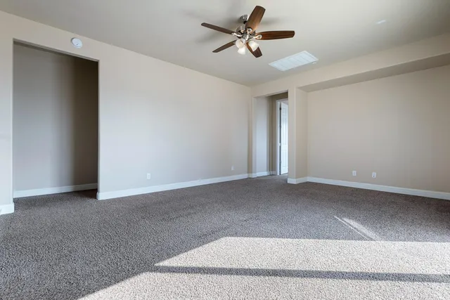 a spacious bathroom with a granite countertop sink and a mirror
