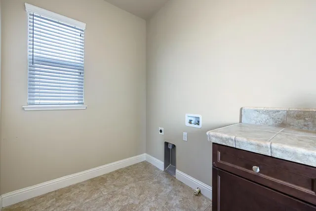 a white bath tub sitting in a bathroom next to a window