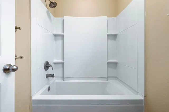 an aerial view of a city with lots of residential buildings ocean and mountain view in back