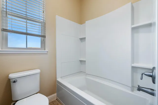 an aerial view of a city with lots of residential buildings ocean and mountain view in back