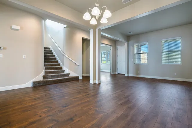 a kitchen with granite countertop a sink stove and cabinets