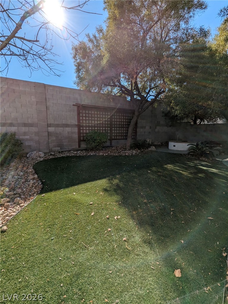 2407 Worchester Road Henderson, NV 89074 - Photo 3 of 5 A private yard with maintenance-free turf and mature shade trees defines outdoor living.