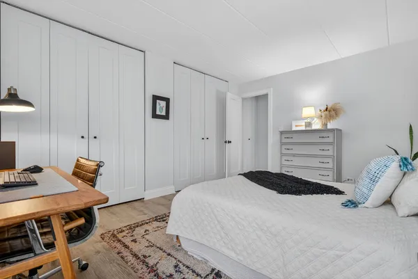 a bedroom with a bed and a table in it