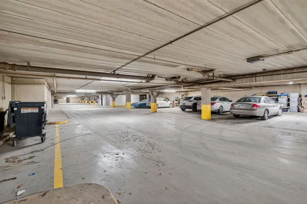 a view of parking garage with cars