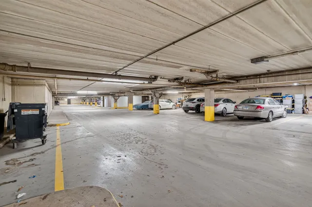 a view of parking garage with cars