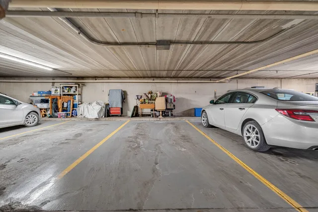 a view of parking garage with cars