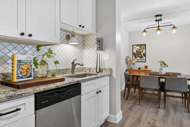 a kitchen with stainless steel appliances granite countertop a sink and cabinets