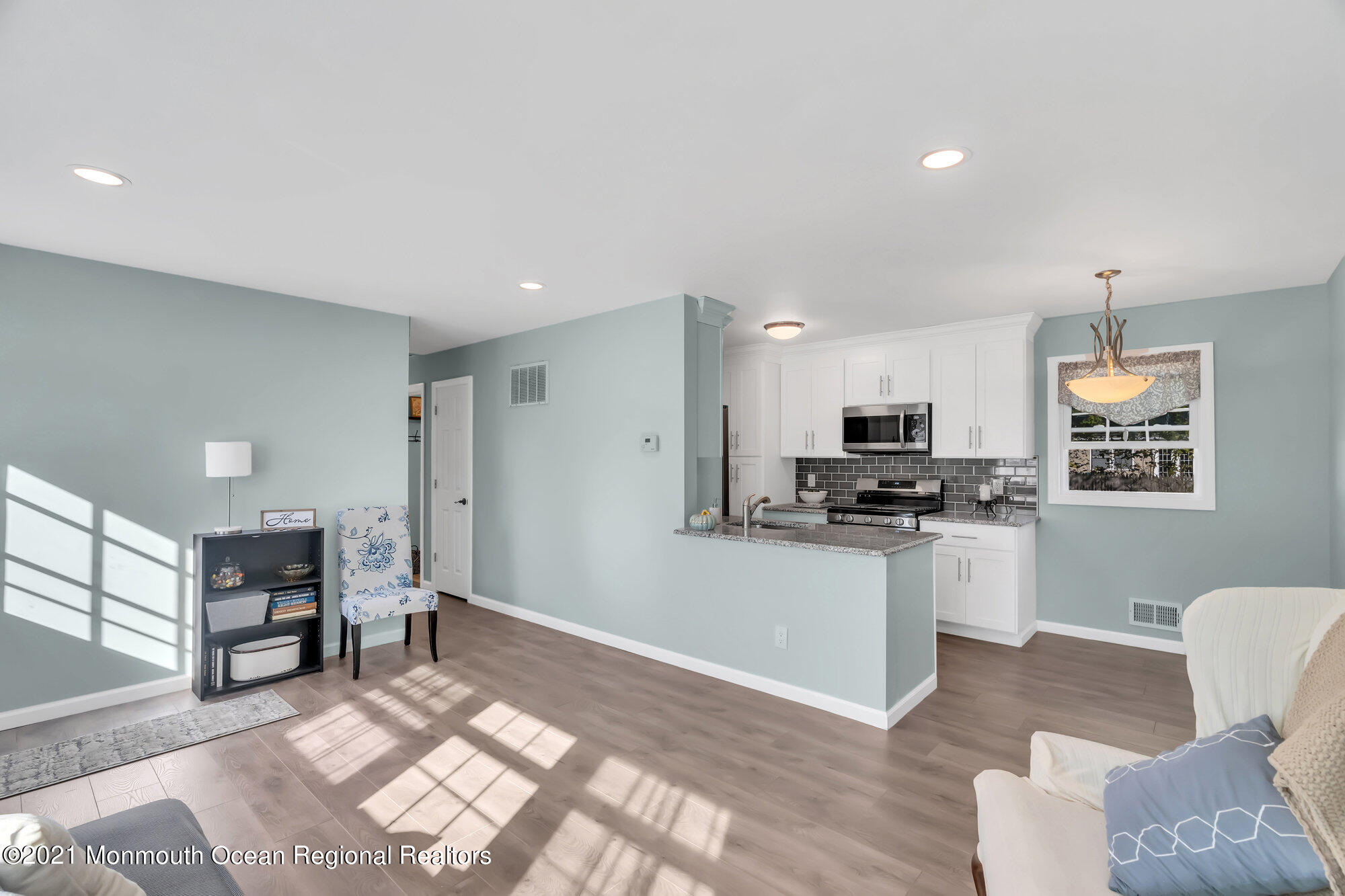 318 Bellanca Road Brick, NJ 08723 - Photo 11 of 23 a kitchen with stainless steel appliances kitchen island granite countertop a refrigerator a stove a sink and a dining table with wooden floor