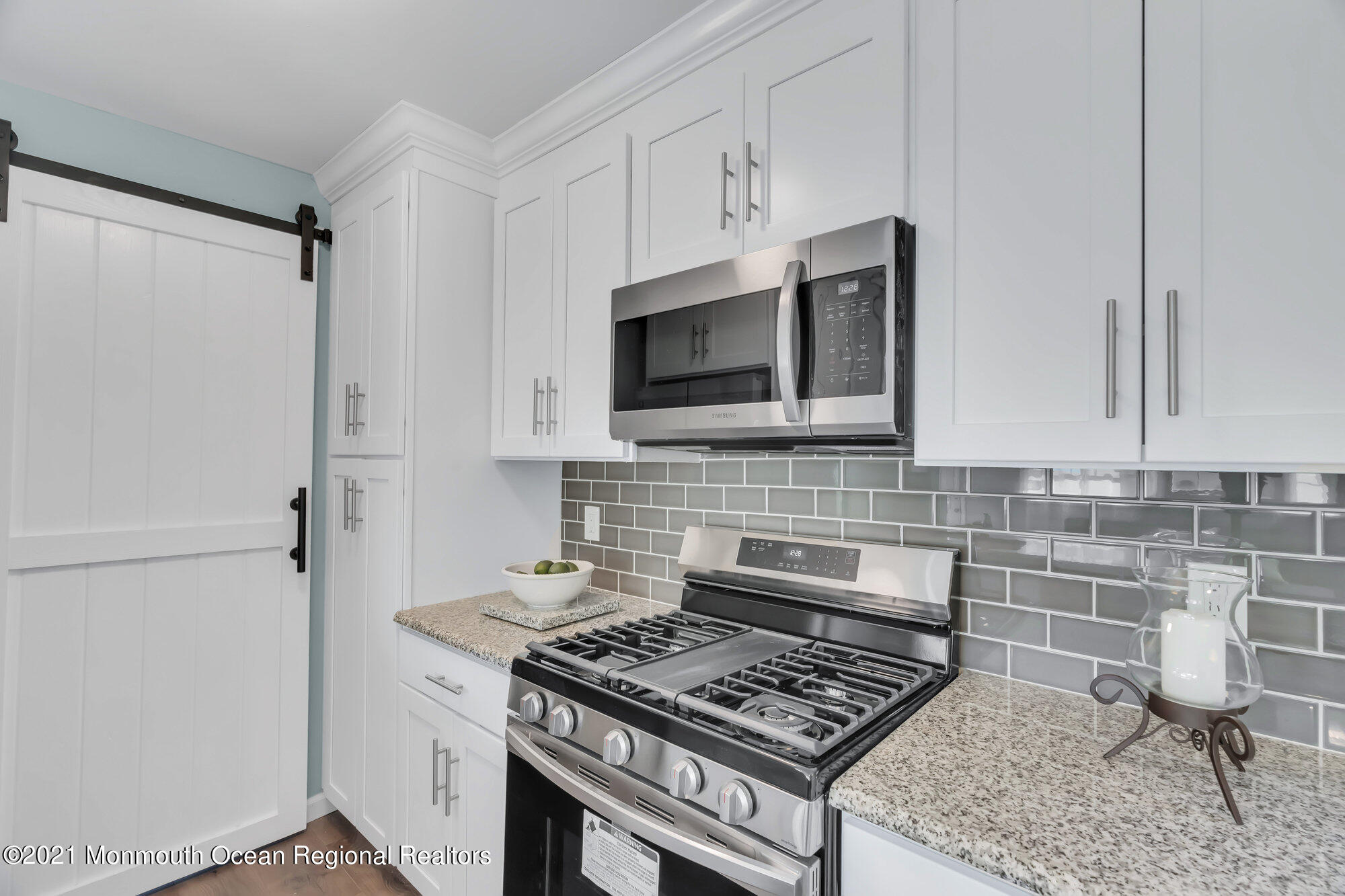 318 Bellanca Road Brick, NJ 08723 - Photo 14 of 23 a kitchen with stainless steel appliances a stove a microwave and cabinets