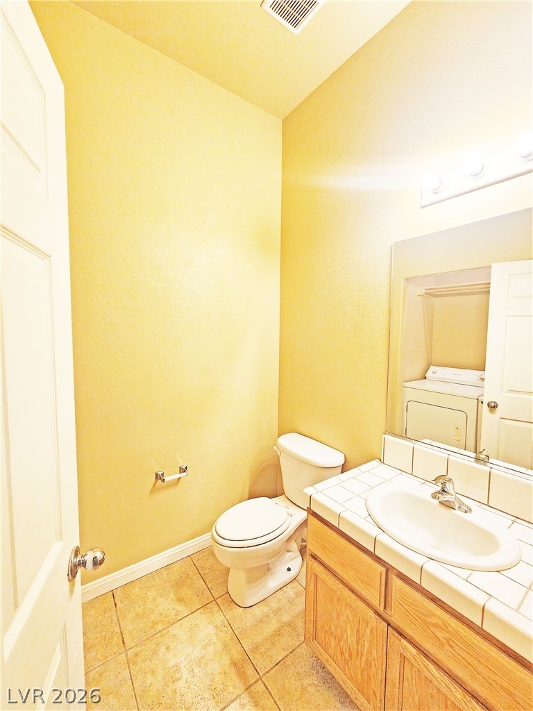 1421 Star Road, Unit 2 Pahrump, NV 89048 - Photo 11 of 33 Bathroom featuring visible vents, tile patterned flooring, vanity, toilet, and washer / dryer