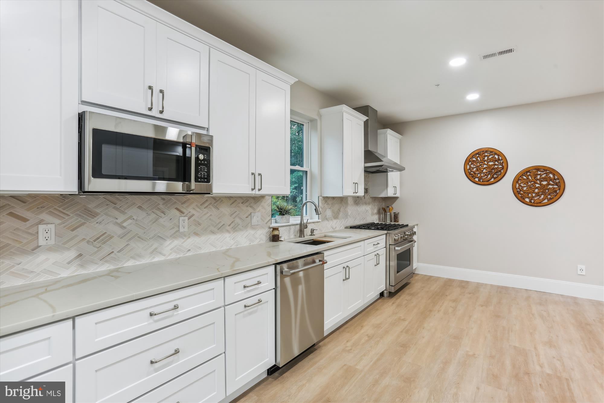 620 Mississippi Avenue Silver Spring, MD 20910 - Photo 15 of 50 a kitchen with stainless steel appliances granite countertop a sink and a microwave