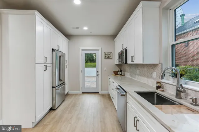 a kitchen with a refrigerator sink and stainless steel appliances