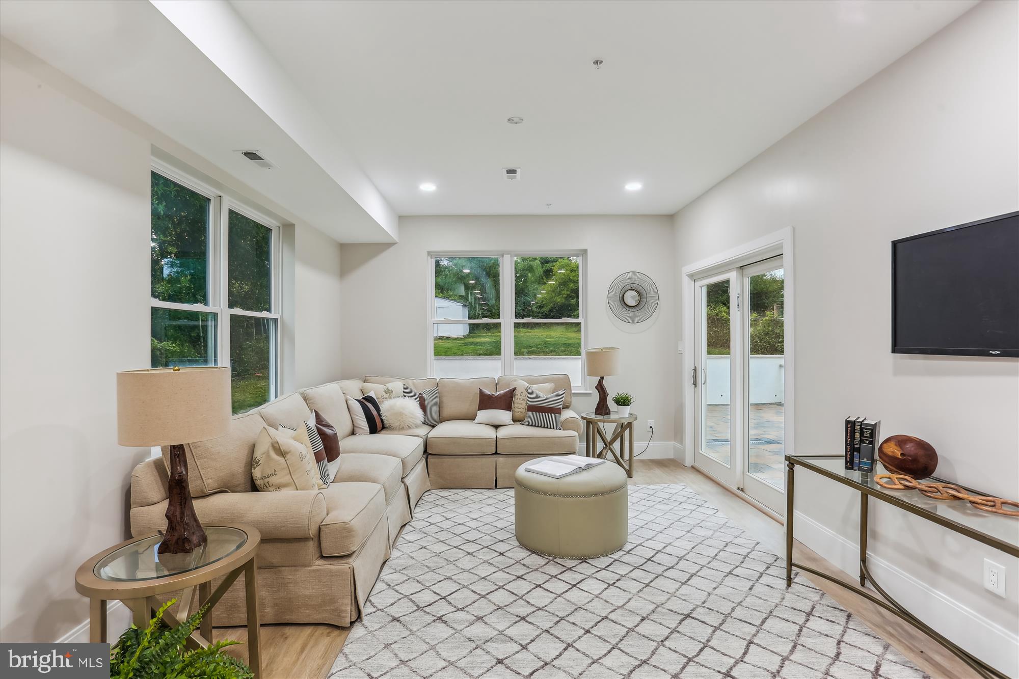 620 Mississippi Avenue Silver Spring, MD 20910 - Photo 18 of 50 a living room with furniture a flat screen tv and floor to ceiling window