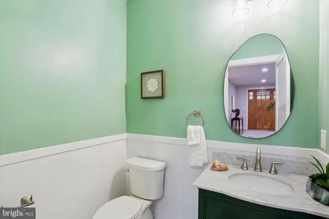 a bathroom with a toilet sink and mirror