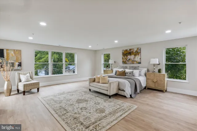 a spacious bedroom with a large bed and a couch