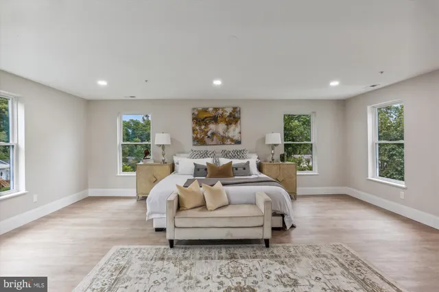 a bed room with furniture and a large window