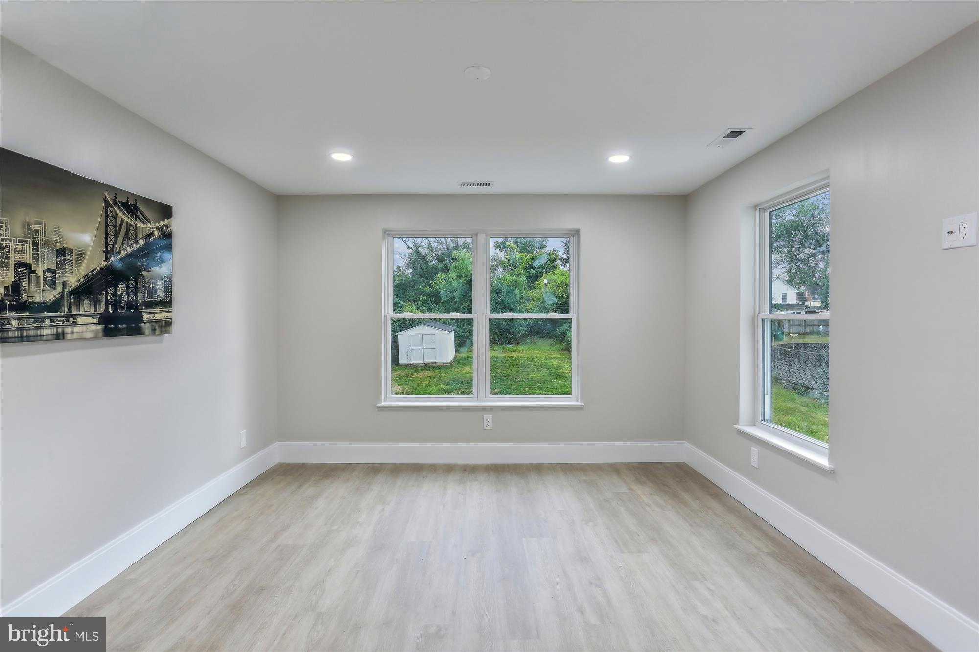 620 Mississippi Avenue Silver Spring, MD 20910 - Photo 38 of 50 a view of an empty room with wooden floor and a window