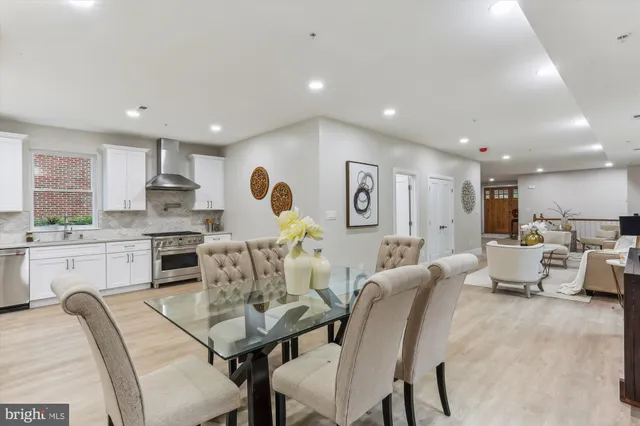 a living room with furniture kitchen view and a stove
