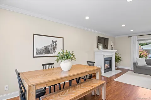 a view of a dining room with furniture and a potted plant