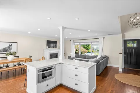 a kitchen with stainless steel appliances granite countertop a stove top oven a sink refrigerator and cabinets