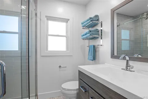 a large bed sitting in a bedroom next to a window