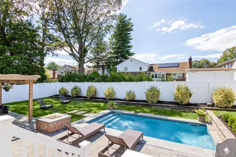 a view of swimming pool with seating space