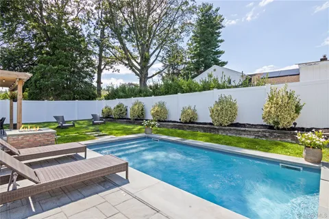 a view of a swimming pool with a yard