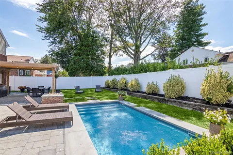 a view of a yard with swimming pool