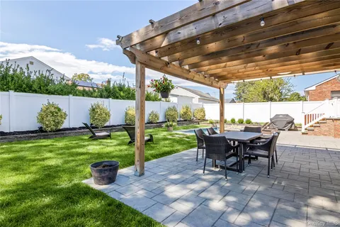 a view of a backyard with sitting area