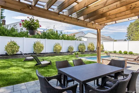 a view of a backyard with table and chairs potted plants with wooden floor
