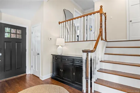 a living room with wooden floor and a fireplace