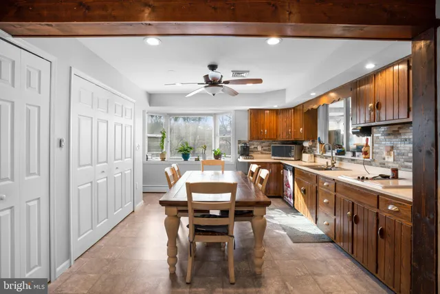 a very nice looking kitchen with a large window appliances and furniture