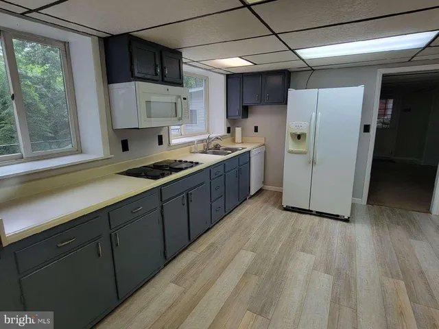 a view of a room with wooden floor and furniture