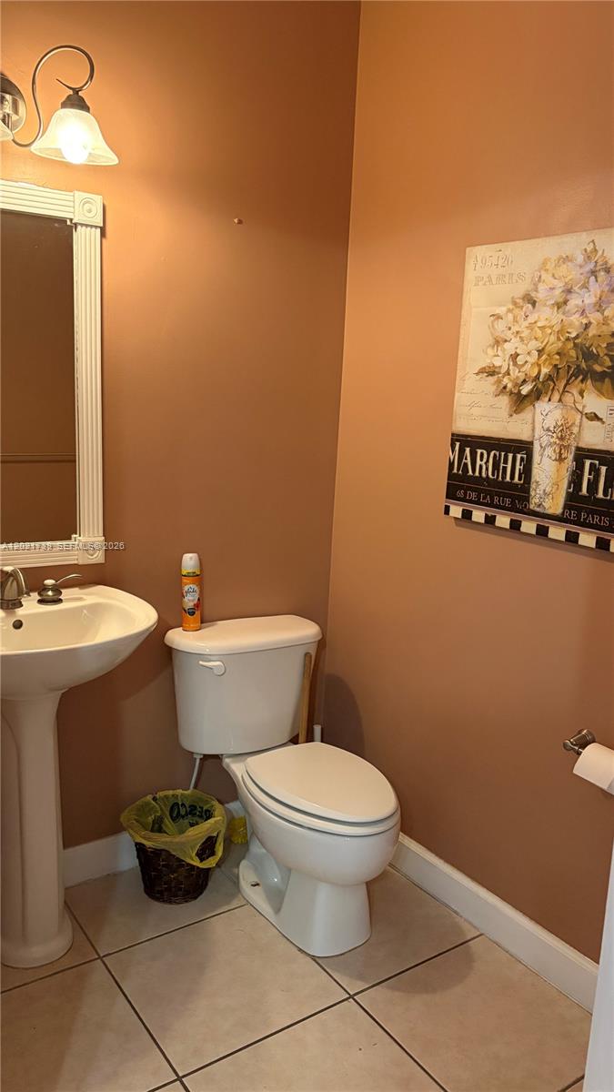 13553 Southwest 124th Avenue Road Miami, FL 33186 - Photo 16 of 31 a bathroom with a toilet and a sink