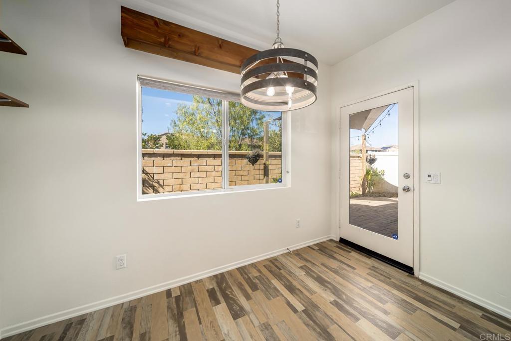 313 Dun Blazer Way Fallbrook, CA 92028 - Photo 15 of 59 a view of a hallway with wooden floor and windows