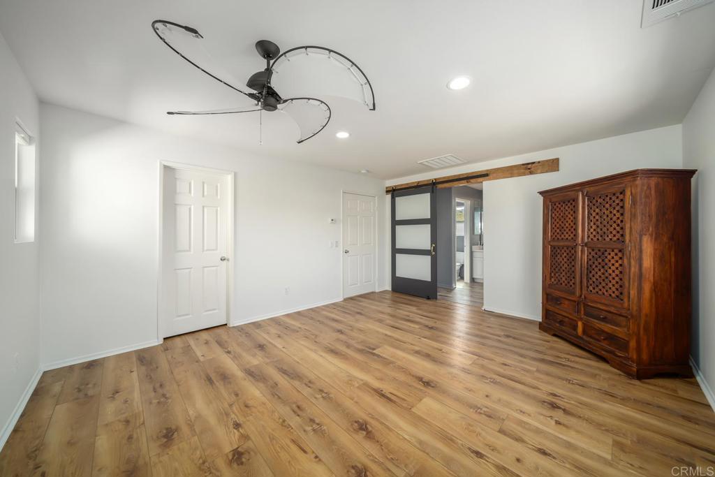 313 Dun Blazer Way Fallbrook, CA 92028 - Photo 25 of 59 a view of an empty room with wooden floor and cabinet