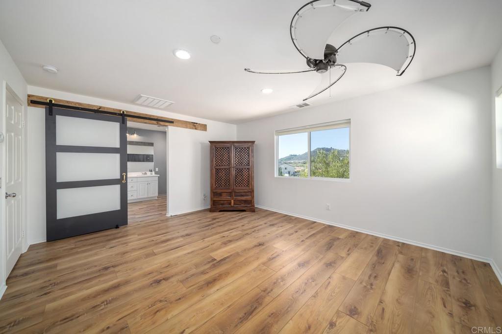 313 Dun Blazer Way Fallbrook, CA 92028 - Photo 26 of 59 a view of empty room with a window and wooden floor