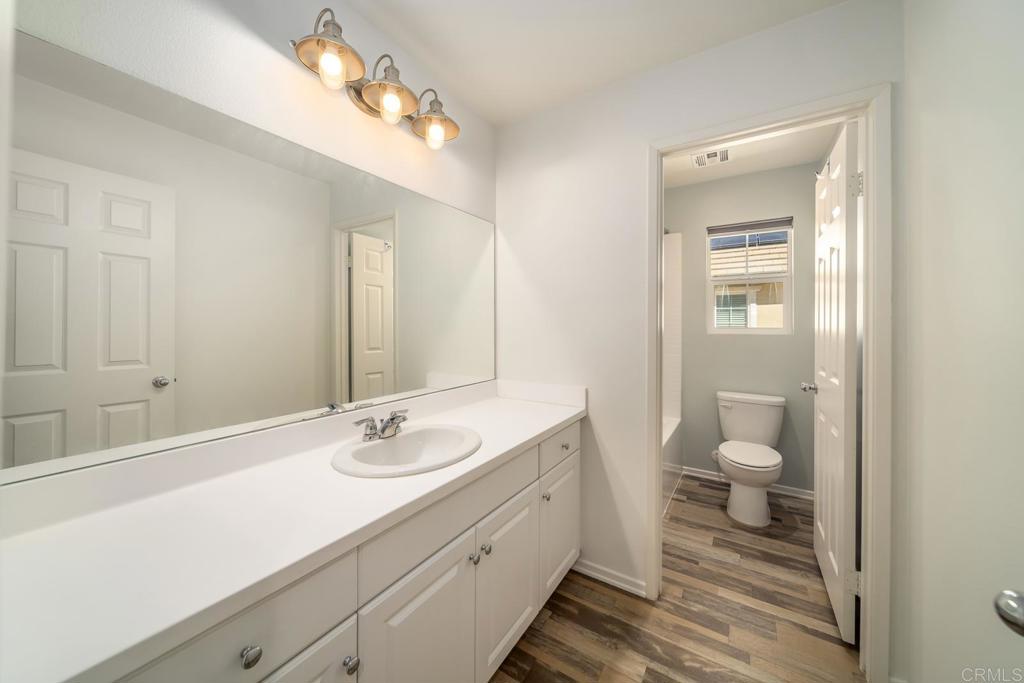 313 Dun Blazer Way Fallbrook, CA 92028 - Photo 28 of 59 a bathroom with a sink a toilet and a mirror