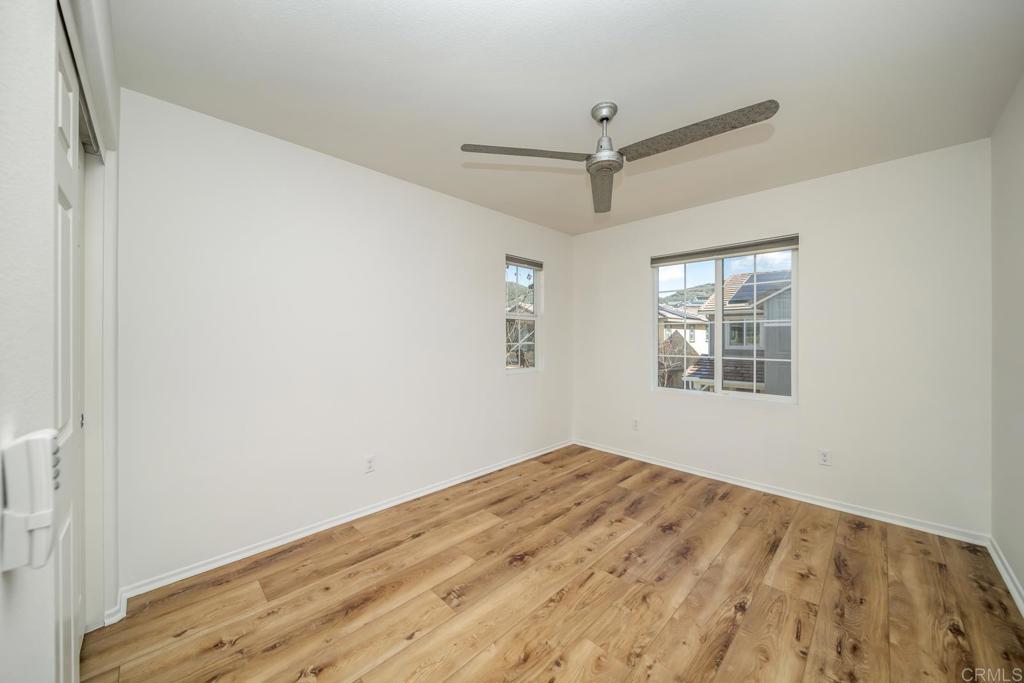 313 Dun Blazer Way Fallbrook, CA 92028 - Photo 30 of 59 a view of empty room with wooden floor and fan